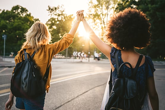 two women high five after preventing overdrafts with gate city bank