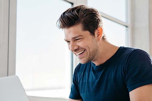 joyful young man takes advantage of financial education resources from Gate City Bank