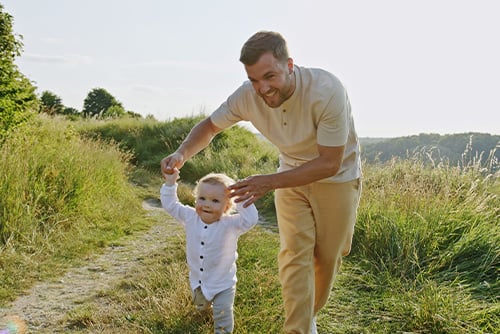 A little boy and his father play at a park in rural North Dakota after visiting their local Gate City Bank