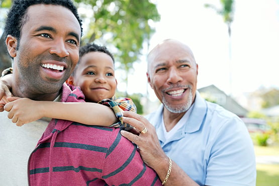 two men laugh and enjoy time together after reading about life insurance options