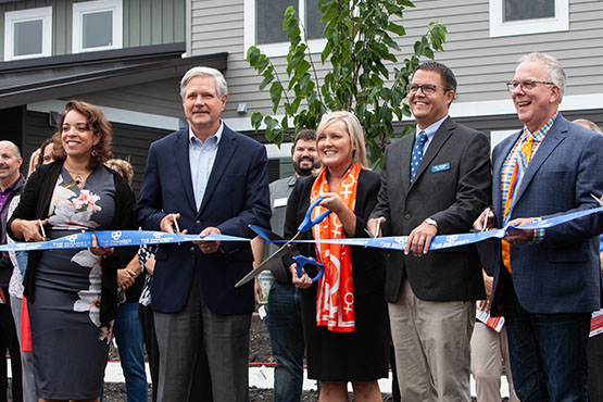 Gate City Bank team members, state reps & community partners unite for the Grace Garden ribbon-cutting for supportive housing