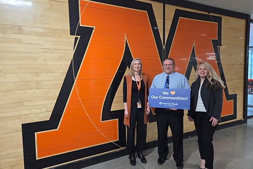 A Gate City Bank team member presents a donation from the My School Spirit program to Moorhead High School in Moorhead, MN. 