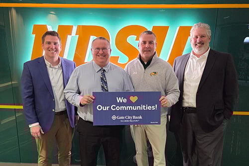 A Gate City Bank team member presents a donation from the My School Spirit program to NDSU in Fargo, ND. 