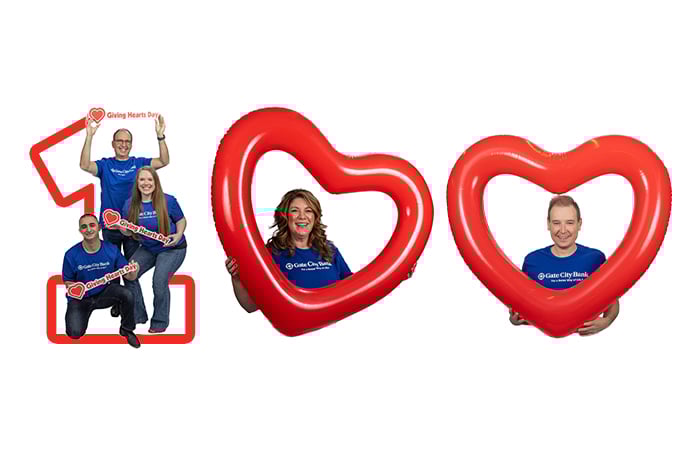 Gate City Bank team members and giant heart shaped balloons form the image of the number 100