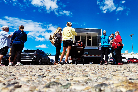 Customers wait for their food outside the Heart-n-Soul food truck in downtown Fargo, ND.