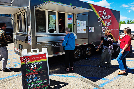 Customers order food at the Heart-n-Soul food truck in downtown Fargo, ND.