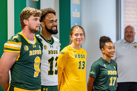 NDSU student athletes sport jerseys with the Gate City Bank logo at a press conference announcing the bank as the first all-sport jersey patch partner of NDSU Athletics.