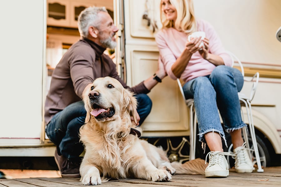 couple with a golden retriever beside their new RV, purchased with a Gate City Bank personal loan in Fargo, ND