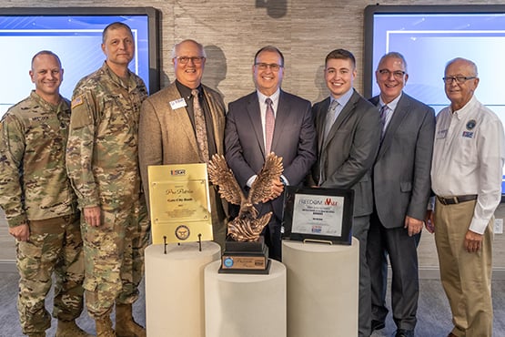A group of men posing for a photo with the 2022 Secretary of Defense Employer Support Freedom Award