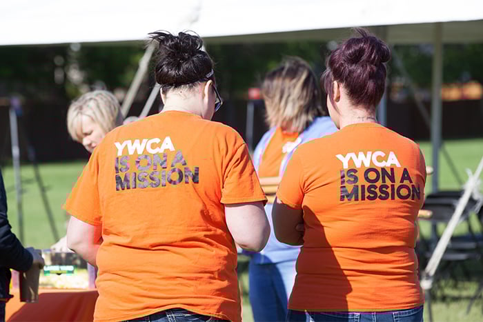 YWCA team members and Gate City Bank volunteers on a sunny day, working together to help women and children in Fargo Moorhead