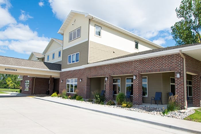 photo of the front of sunshine hospitality home on a sunny day with a donation from gate city bank
